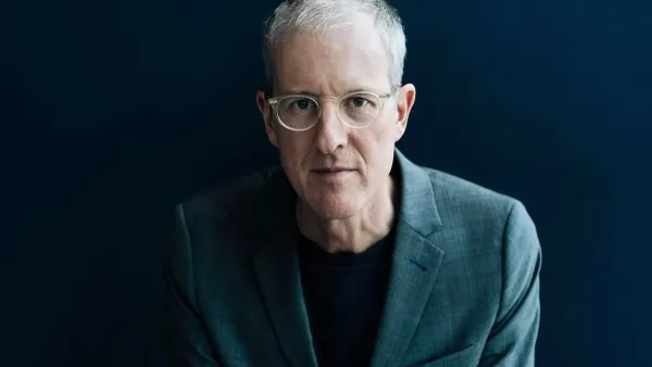 Headshot of Jeff Speck in grey suit against dark backdrop.