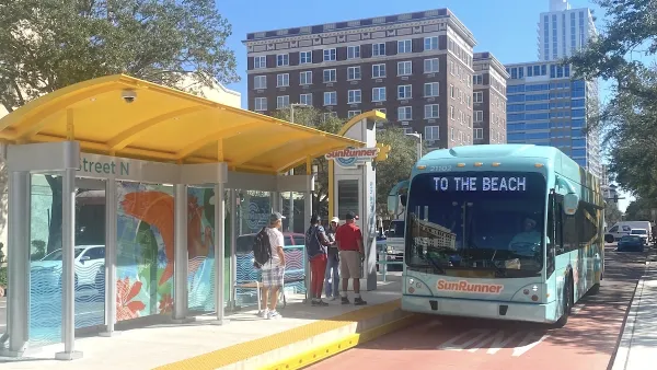 Blue SunRunner bus in Tampa Bay at station with dedicated bus lane, marquee reads "To the beach."