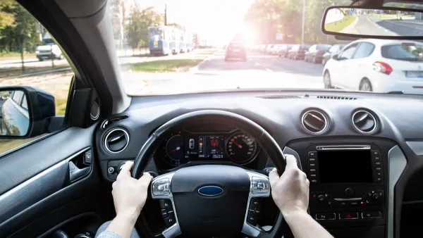 View from inside car's driver seat while driving.