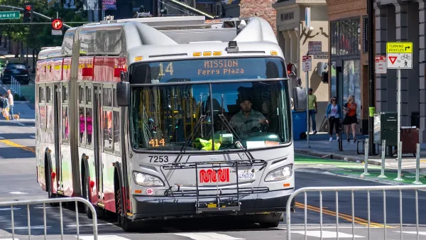 San Francisco Muni bus on street, line 14 with MISSION - Ferry Plaza" on front marquee.