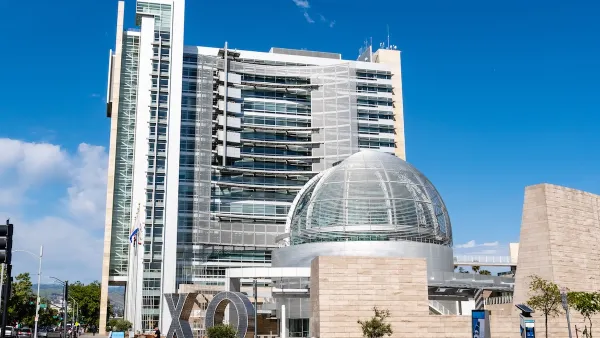 San Jose, California city hall with glass dome in front of modern multistory building.