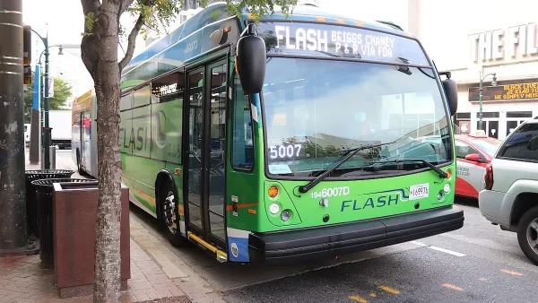 Green public transit bus at stop in Silver Spring, Maryland.