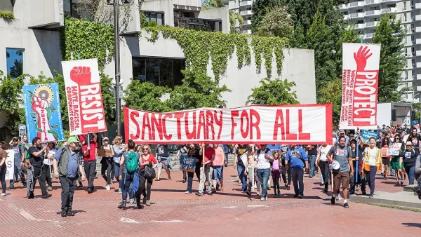 Group protesting during May Day 2017 holding sign that reads "Sanctuary for all" in San Francisco, California.