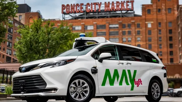 White May Mobility self-driving van with Lyft logo with Ponce Public Market sign in background in Atlanta, Georgia.
